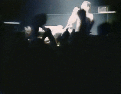 a blurred image of a man with his arms outstretched