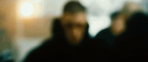 a blurry picture of a man with a hood on