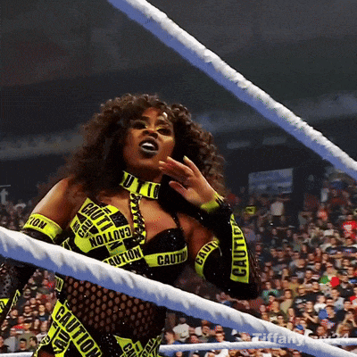 a woman in a wrestling ring with caution tape on her arms
