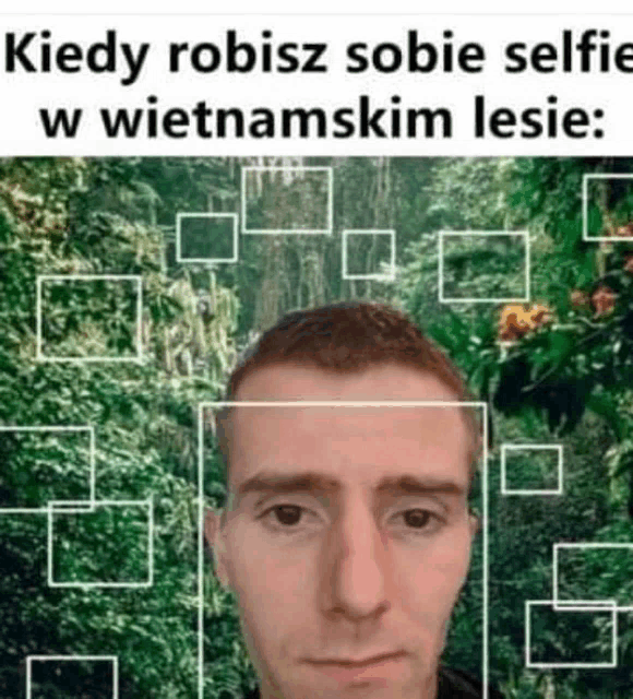 a man is taking a selfie in the woods in a foreign language .