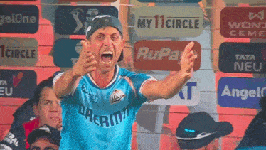 a man wearing a blue shirt that says dharma is screaming