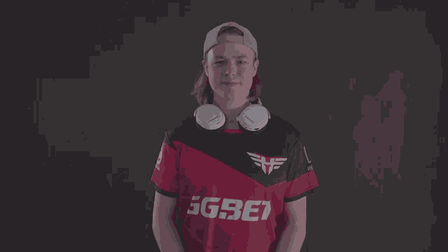 a man wearing headphones and a ggbet jersey