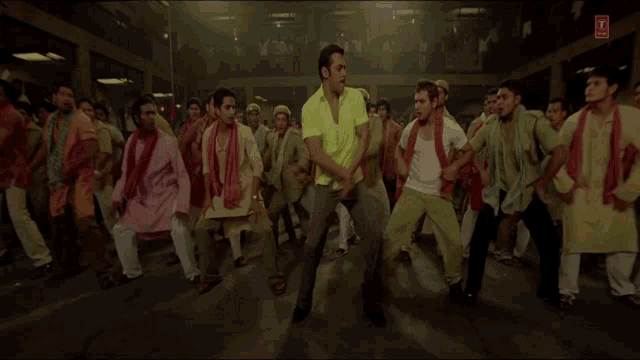 a man in a yellow shirt is surrounded by other men