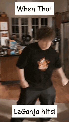 a man in a black shirt is dancing in a kitchen with a caption that says when that leganja hits