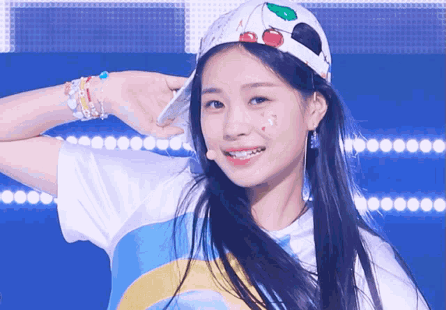 a girl wearing a hat with a cherry on it