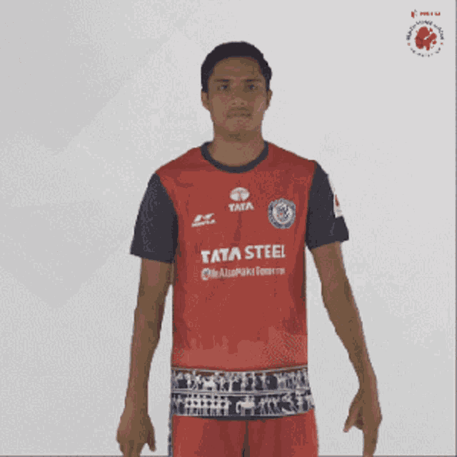 a man in a red and blue shirt that says tata steel