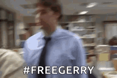 a man in a blue shirt and tie is walking in an office and says `` free gerry '' .