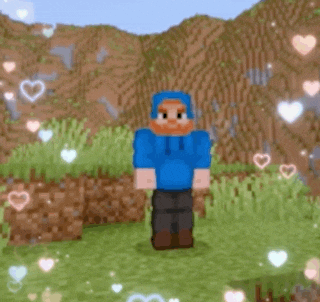 a man with a beard is wearing a blue hoodie and standing in the grass .
