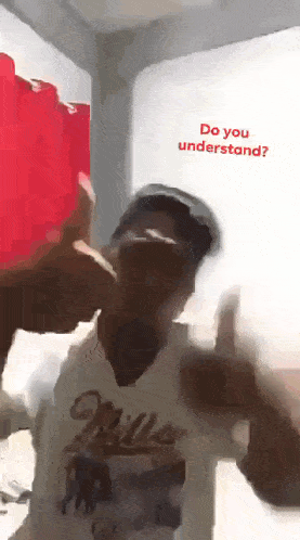 a man giving a thumbs up with the words do you understand behind him