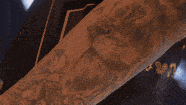 a close up of a person 's arm with a tattoo that says ' jesus ' on it
