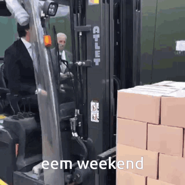 a man in a suit is driving a forklift with the words " eem weekend " on the bottom