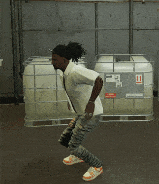 a man is dancing in front of a container that says liquid flammable