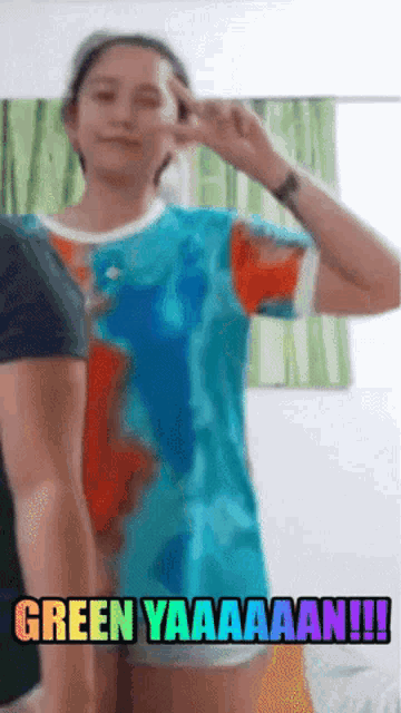a woman in a tie dye shirt says green yaaaaaan