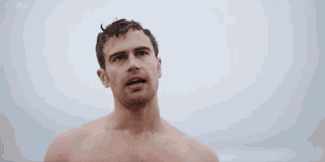 a shirtless man is standing in front of a white background .