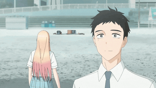 a man and a girl are standing on a beach