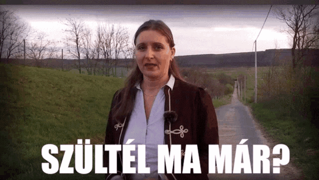 a woman standing on a road with the words szultel ma mar written in white
