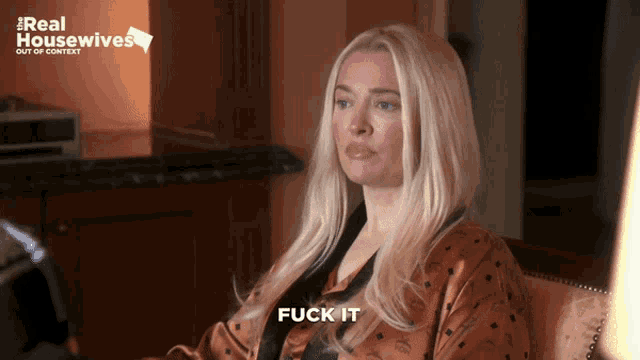a woman is sitting in front of a sign that says " real housewives "