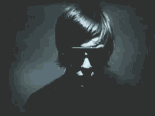 a silhouette of a person wearing sunglasses with their mouth open