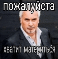 a man in a suit and tie is standing in front of a black wall with a foreign language caption .