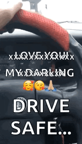a person is holding a red steering wheel cover in a car and says drive safe .