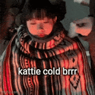 a girl is wrapped in a blanket and says katie cold brrr