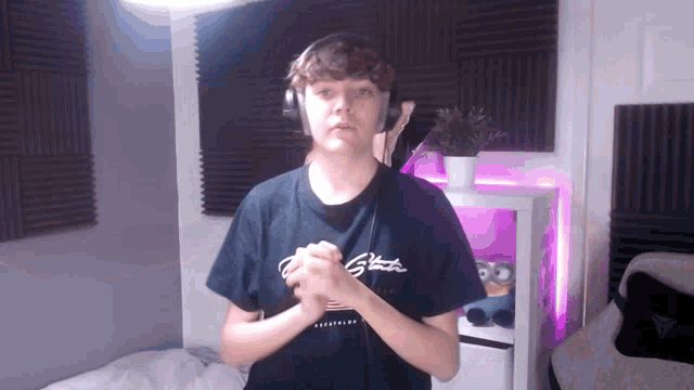 a young man wearing headphones and a black shirt that says g-funk