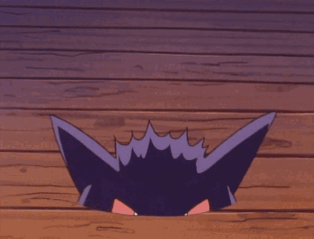 a purple monster with red eyes and a large smile