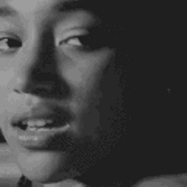 a black and white photo of a woman 's face in a black and white photo .