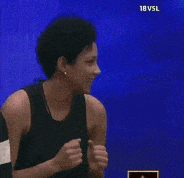 a woman in a black tank top stands in front of a blue background with the words 18 vsl on it