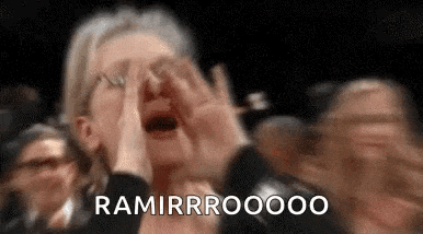 a woman is covering her face with her hands while screaming in a crowd of people .