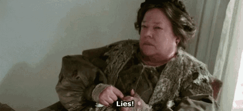 a woman is sitting on a couch with a napkin in her hand and says lies .