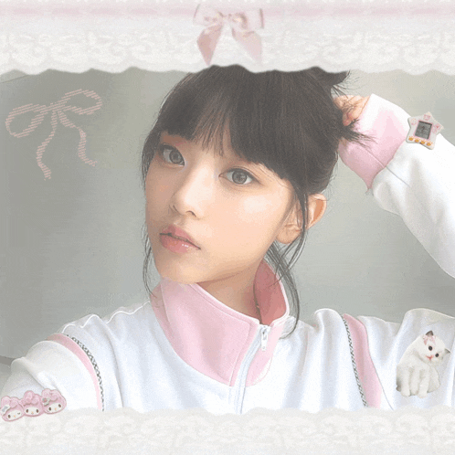 a girl in a pink and white jacket with a watch on her wrist