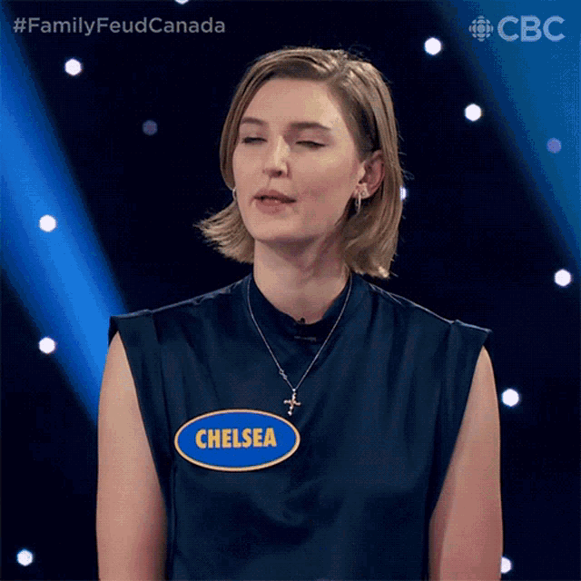 a woman wearing a blue shirt with the name chelsea on it