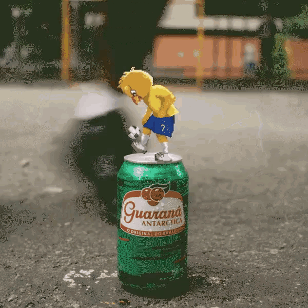 a green can of guarana antarctica sits on a concrete surface