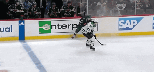 a hockey game is being played in front of a sign that says sap