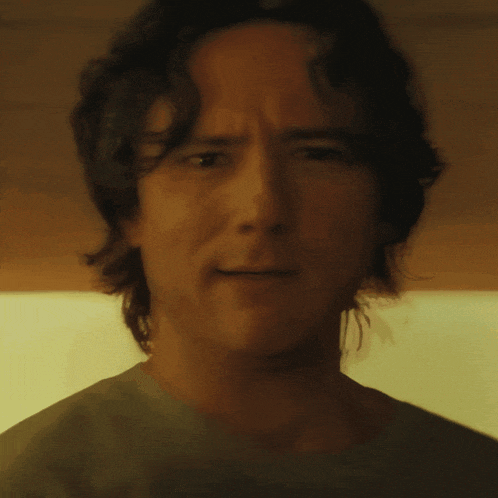 a close up of a man 's face with his eyes closed and his mouth open