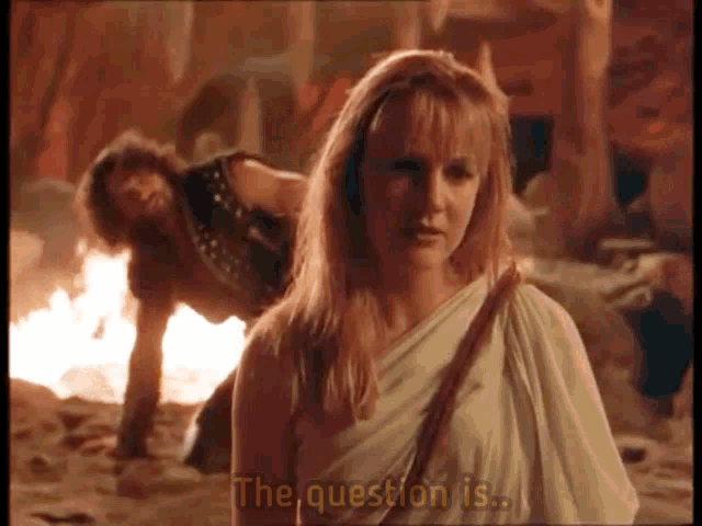 a woman is standing in front of a man with the question is written on the screen