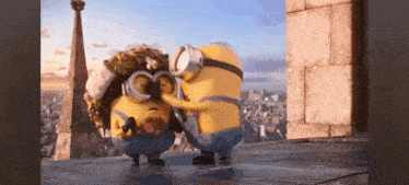two minions are standing next to each other on a rooftop .