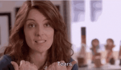 a woman is making a face and saying `` tears '' with her hands .