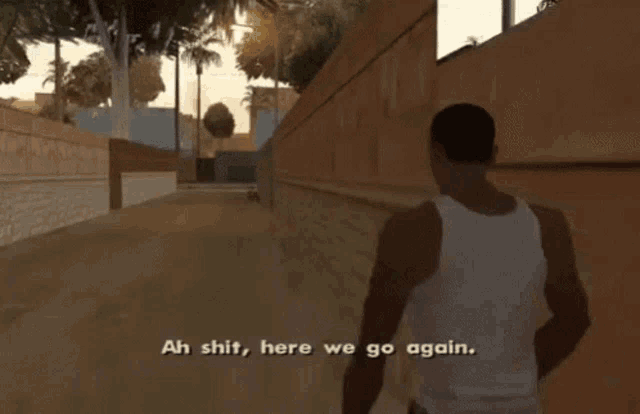 a man in a white tank top walks down a street and says " ah shit here we go again "