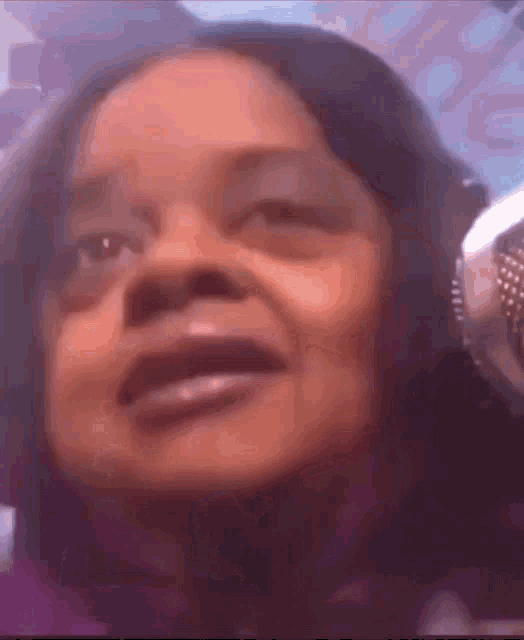 a close up of a woman 's face with headphones on .