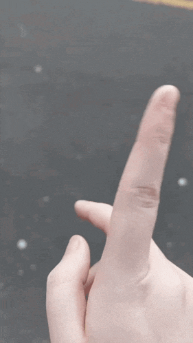 a blurry picture of a person 's thumb pointing up