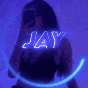 a woman is taking a picture of herself with the name jay glowing in the background