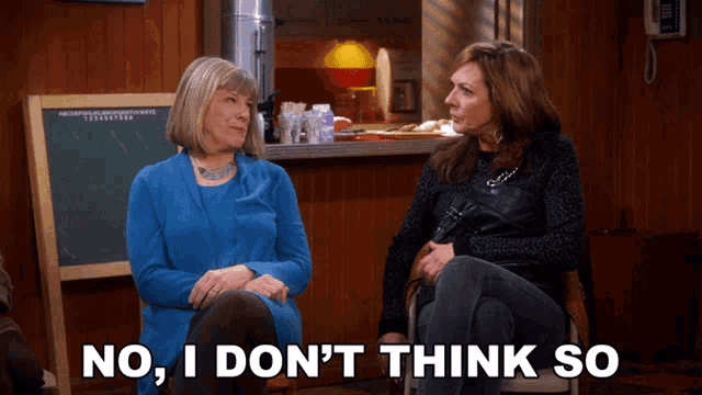 two women sit in front of a chalkboard with the words no i don 't think so
