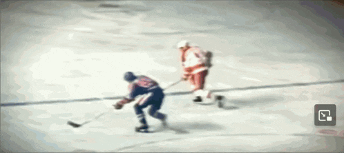 a hockey game is being played on a ice rink with a player wearing number 23