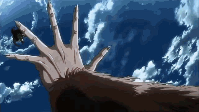 a person 's hand is reaching out towards the sky