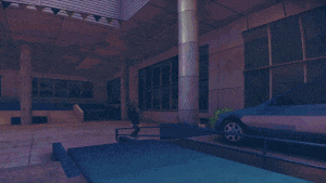 a car is parked in front of a building with the letter t on the fence
