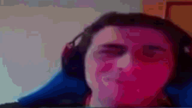 a blurry image of a person 's face with a blue background