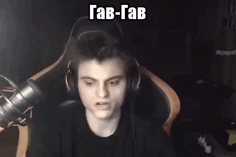 a young man wearing headphones is sitting in a chair in front of a microphone .