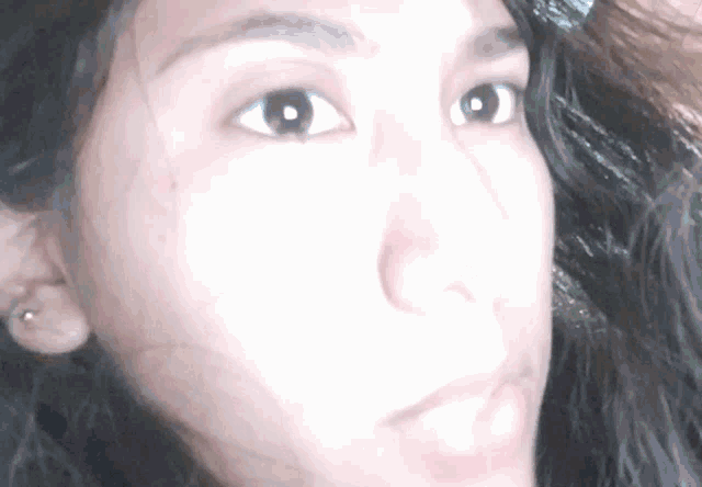 a close up of a woman 's face shows her eyes and nose